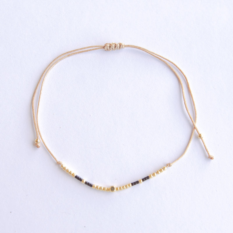 Add a pop of subtle color to your style with our Gleam Beads Adjustable Anklets. Featuring delicate colorful and gold beads on a silky cotton string, these adjustable anklets are perfect for layering, with five colors available to create your unique combinations.