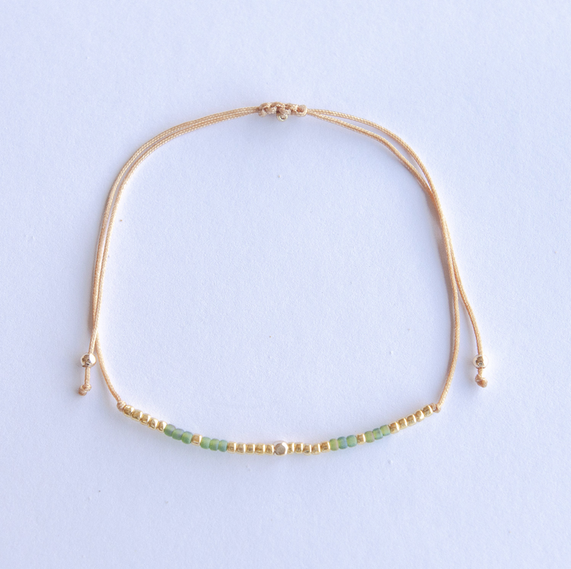 Add a pop of subtle color to your style with our Gleam Beads Adjustable Anklets. Featuring delicate colorful and gold beads on a silky cotton string, these adjustable anklets are perfect for layering, with five colors available to create your unique combinations.