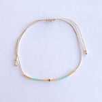 Add a pop of subtle color to your style with our Gleam Beads Adjustable Anklets. Featuring delicate colorful and gold beads on a silky cotton string, these adjustable anklets are perfect for layering, with five colors available to create your unique combinations.