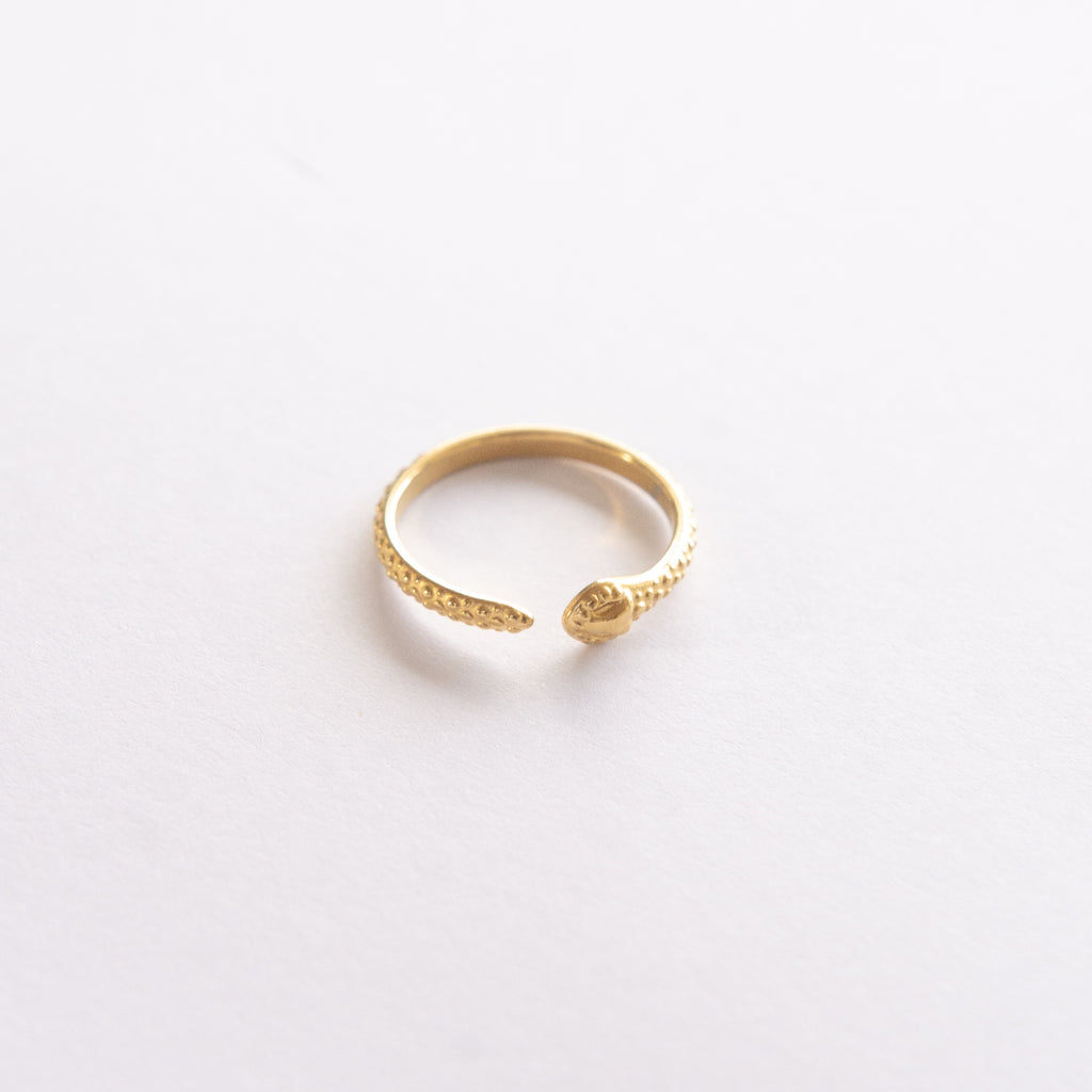 This trendy and durable snake ring is perfect for any occasion. Made with high-quality stainless steel and 14K gold plating, it ensures a long-lasting shine and tarnish resistance.  The adjustable fit allows for versatile wear on any finger, making it an ideal accessory. Shop now and add a unique touch to your jewelry collection!