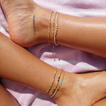 Elevate your style with our Gold String Anklet featuring genuine freshwater pearls. This trendy anklet is perfect for adding a touch of coastal charm to any outfit, whether at the beach or in the city.